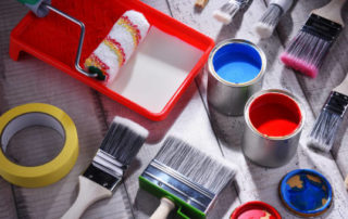 Paint Can And Paintbrushes Of Different Size For Home Decorating Purposes.