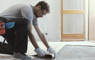 Contractor Removing An Old Linoleum Flooring